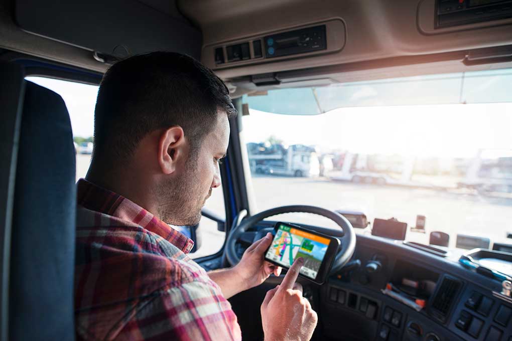 Truck driver using a GPS navigator